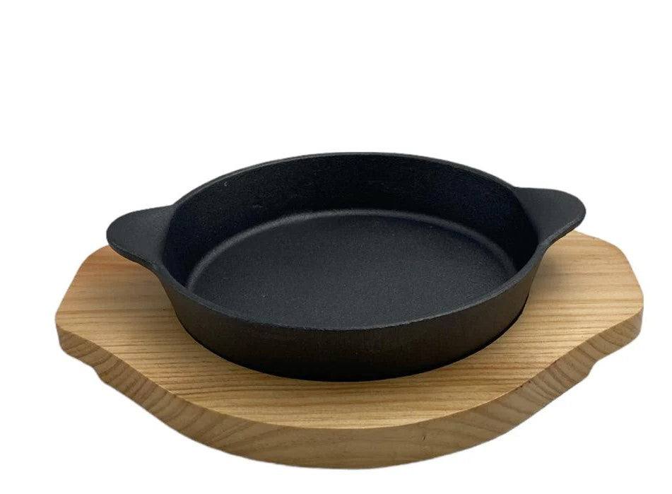 Cast iron round sizzling platter with wooden board